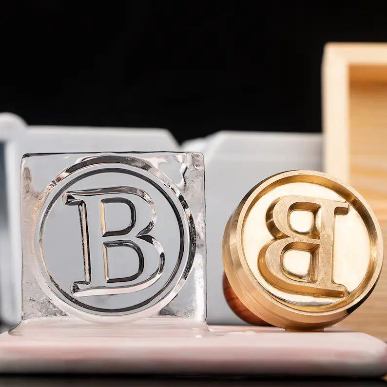 custom brass ice stamp embossing a logo on clear cocktail ice cube with wooden handle